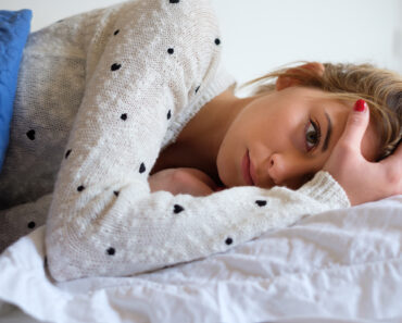 Girl feeling bad and trying to sleep